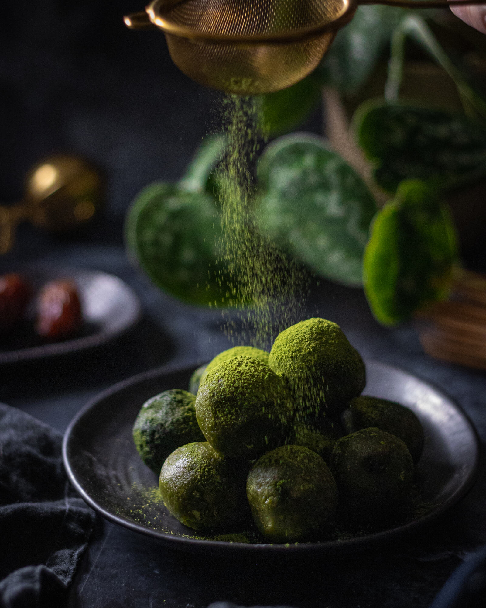 matcha energy balls on a black plate