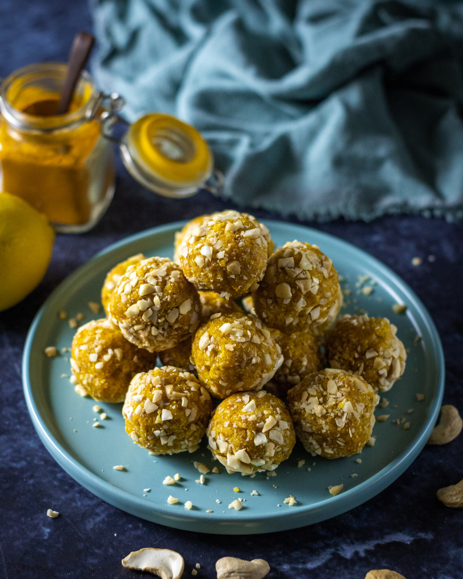 a stack of turmeric energy balls on a blue plate