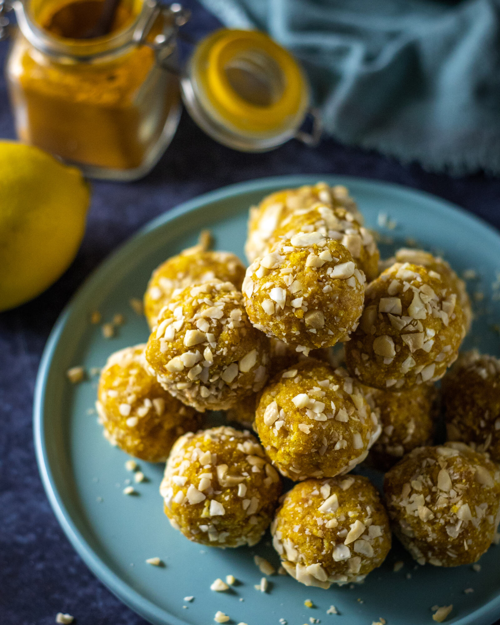 a stack of turmeric energy balls on a blue plate