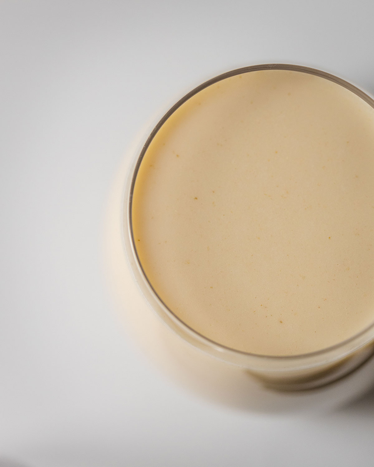easy homemade oat milk in a glass, photographed from above