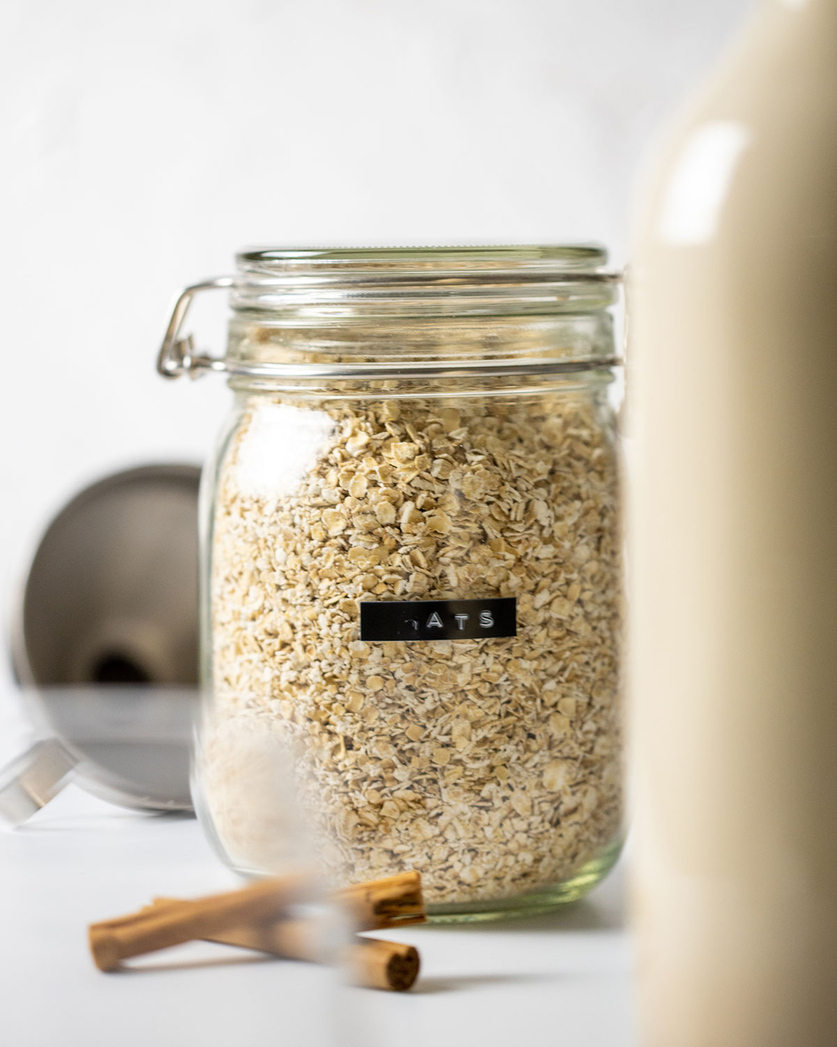 glass jar full of gluten free oats, used to make easy homemade oat milk gluten free