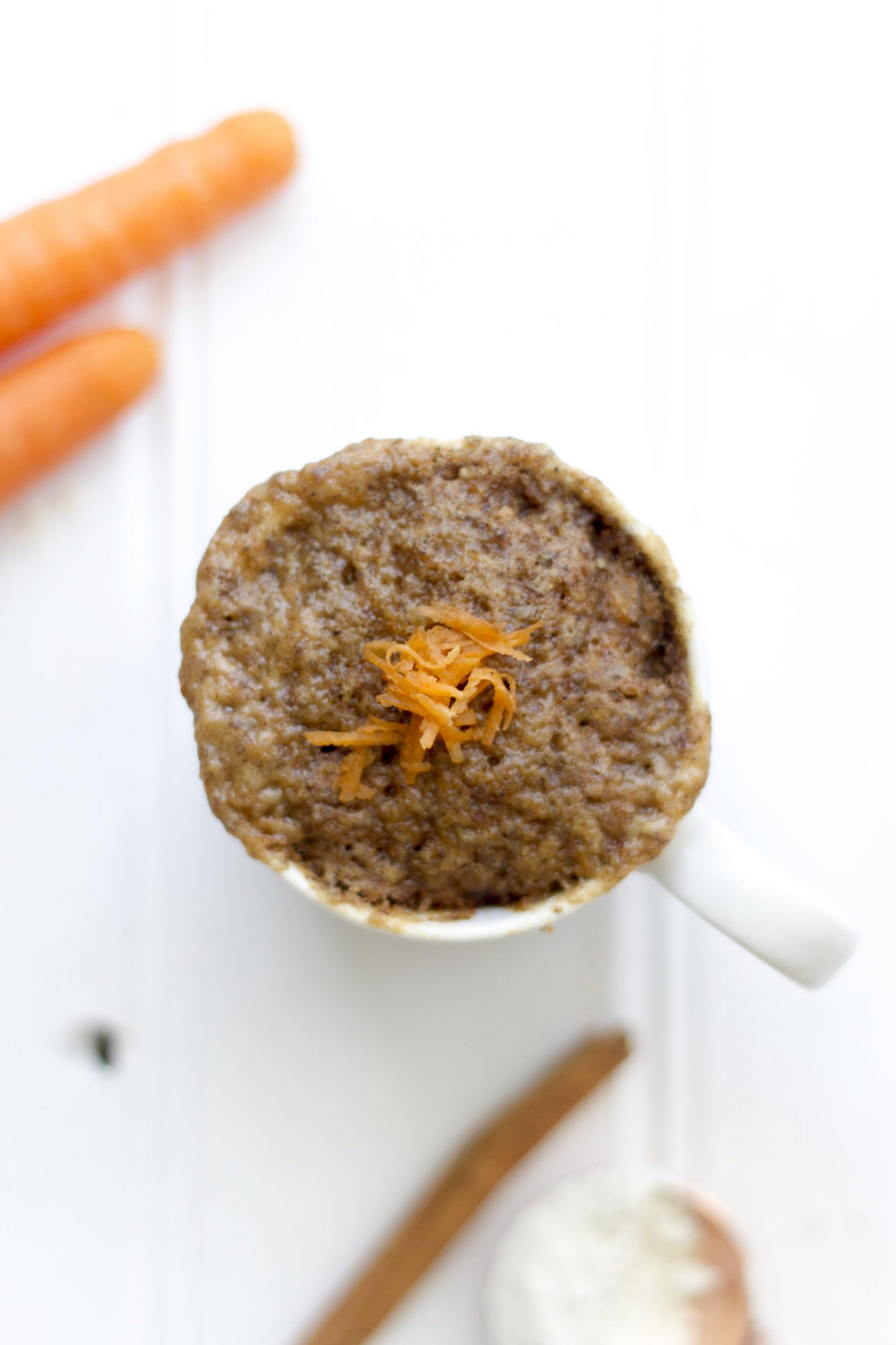 Vegan carrot cake mug cake photograph from above on a white background