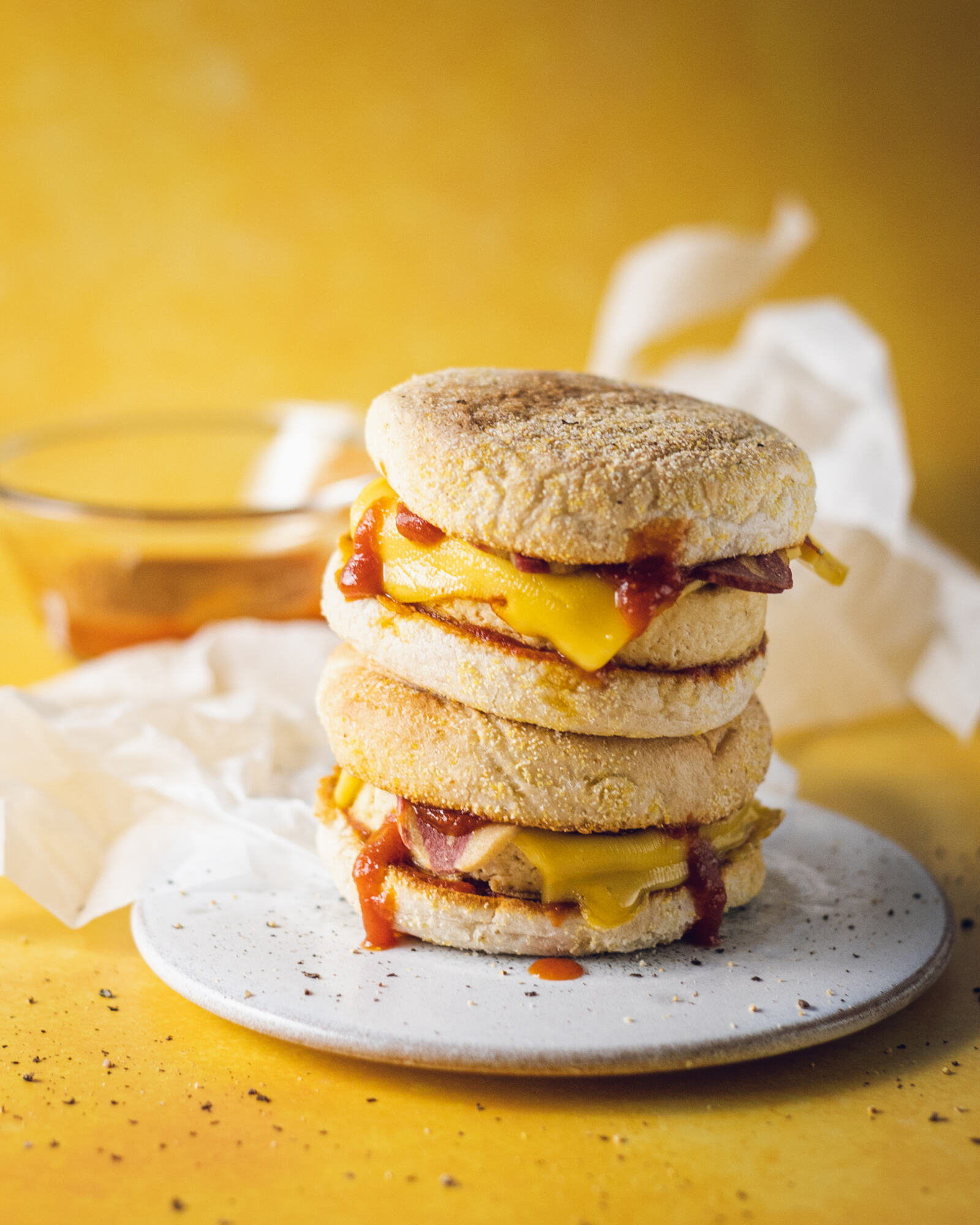 2 vegan egg mcmuffins stacked on a white plate