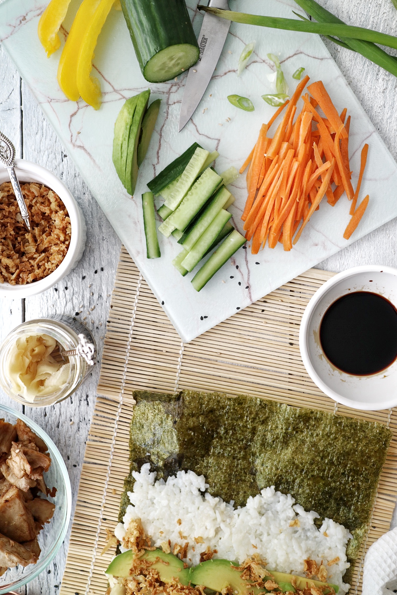 sliced vegetables for vegan sushi burrito on a chopping board