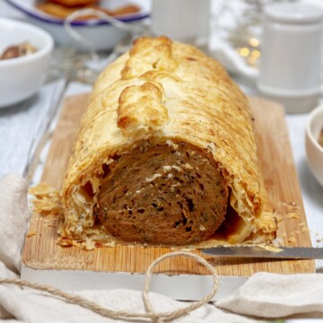 sliced homemade vegan seitan wellington on a serving board