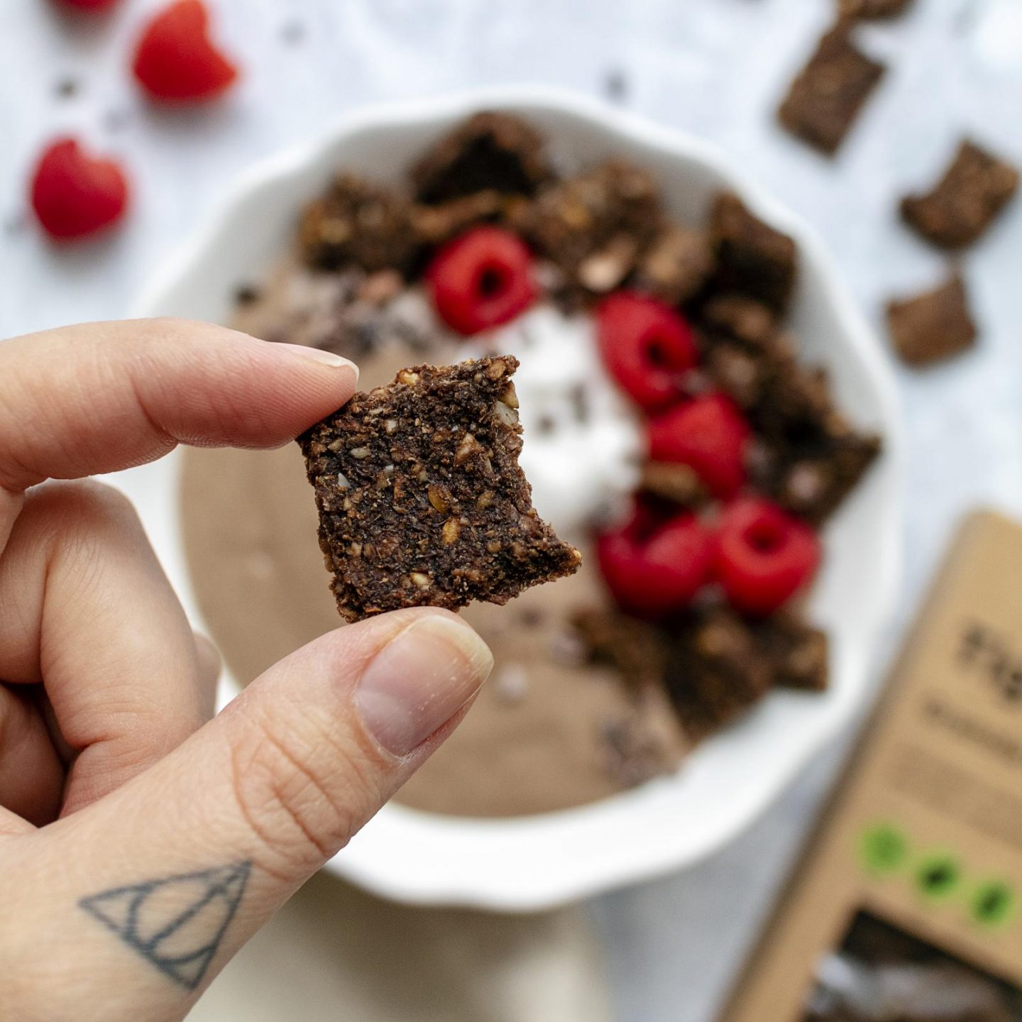 hand holding a piece of Erbology Tigernut Granola