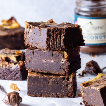 a stack of Vegan Chocolate Swirl Brownies with a bite taken out of the top slice