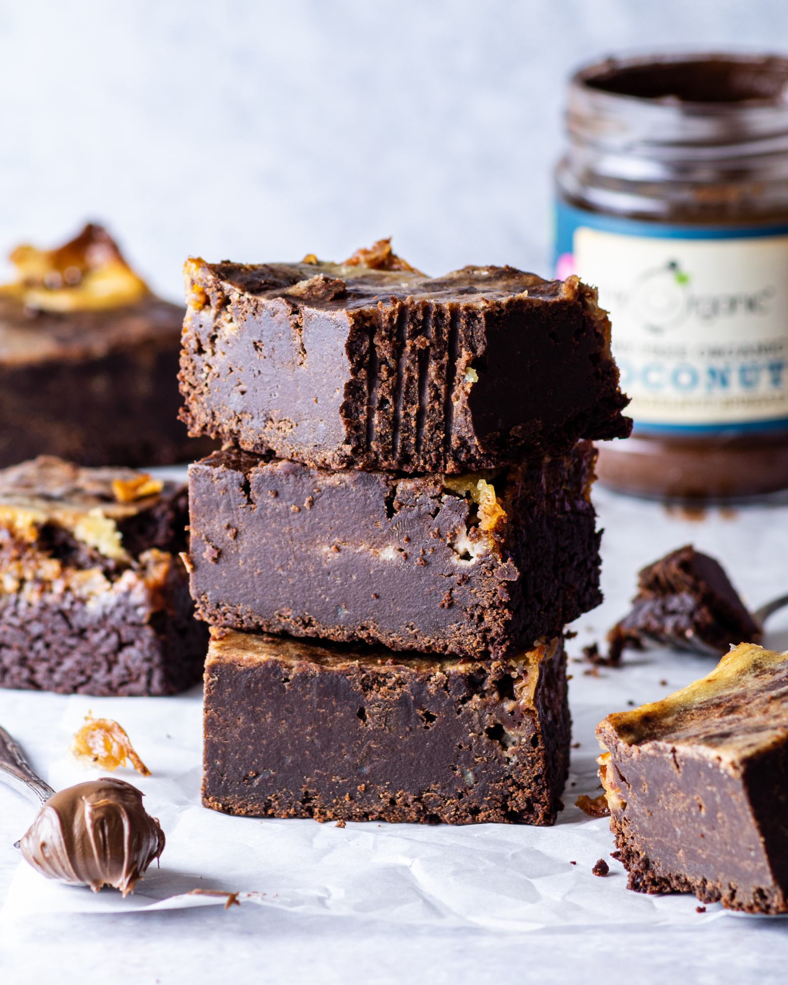 a stack of Vegan Chocolate Swirl Brownies with a bite taken out of the top slice