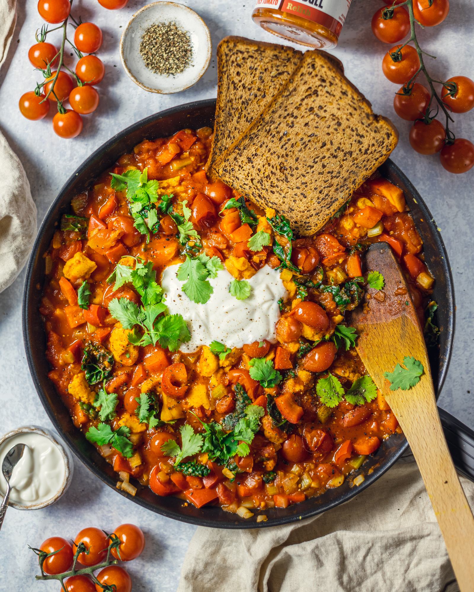 Vegan Shakshuka Recipe without tofu in a large skillet on a white table