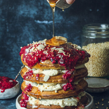 Maple syrup being poured onto Fluffy Vegan Buttermilk Pancakes