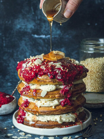 Maple syrup being poured onto Fluffy Vegan Buttermilk Pancakes