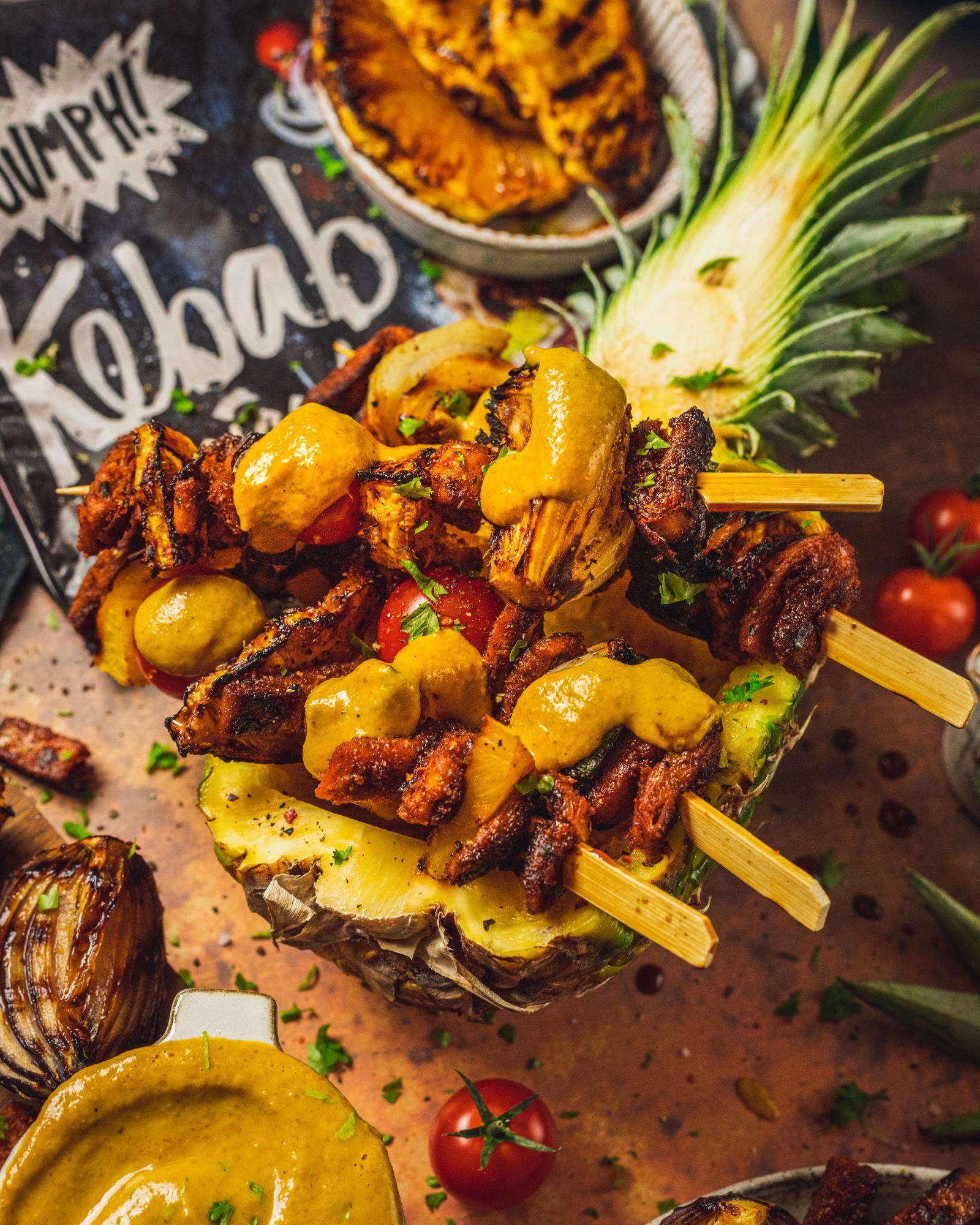 veggie skewers serves on a pineapple and topped with vegan pineapple bbq sauce