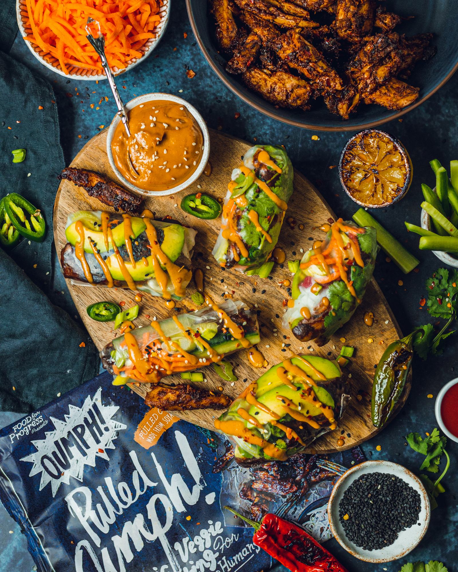 Simple Vegan Summer Rolls on a serving board with vegan peanut dip on the side