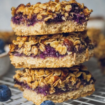 Blueberry Oat Crumble Bars stacked on a cooling rack