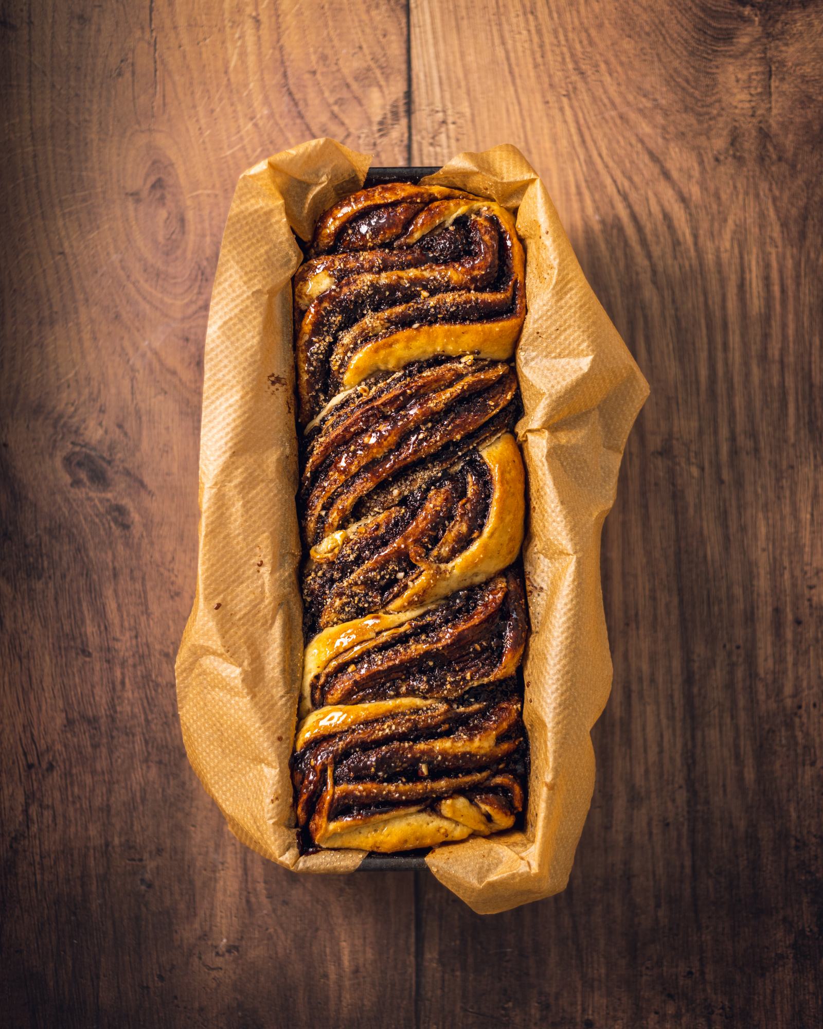 Freshly baked chocolate babka in a loaf pan.