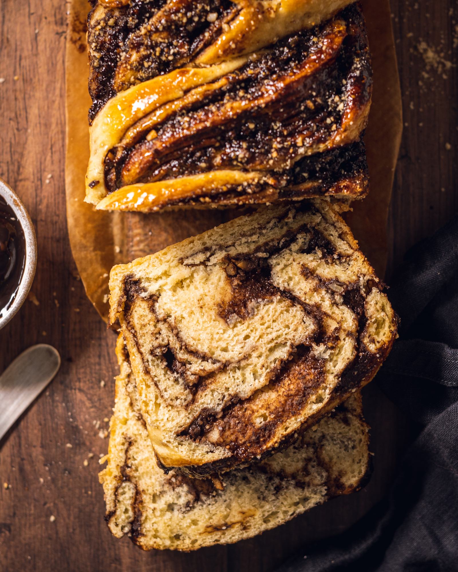 Sliced chocolate babka on a serving board.