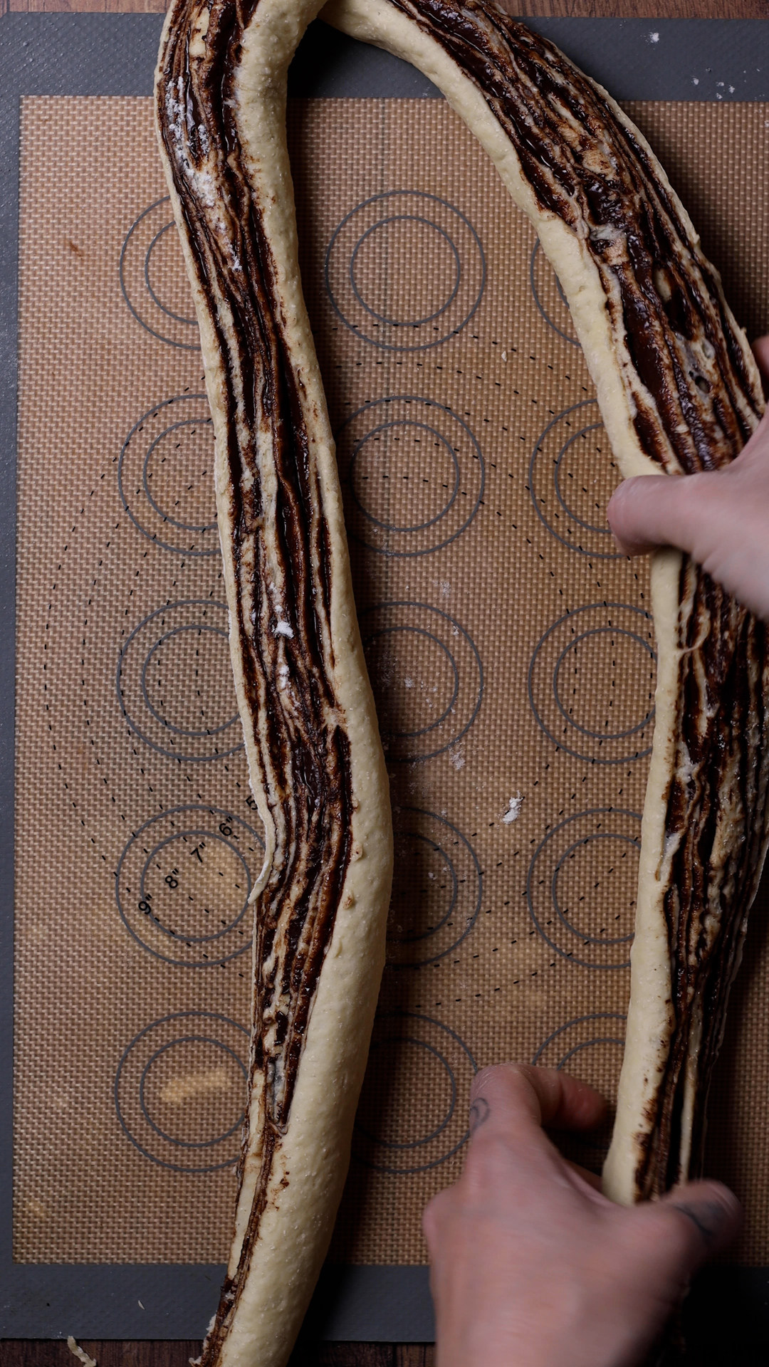 Hands twisting the babka dough.