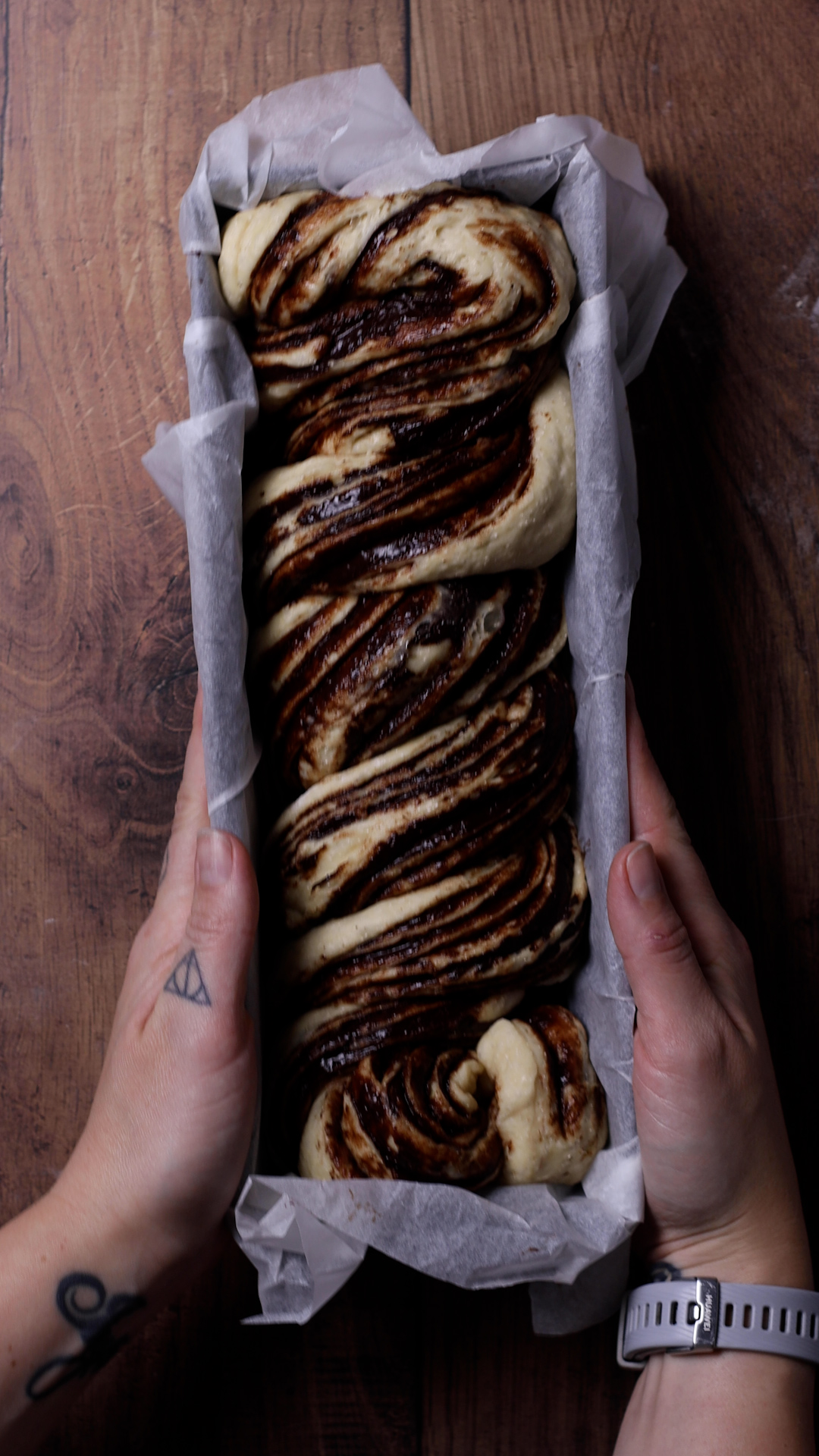 the twisted babka in a loaf tin before baking