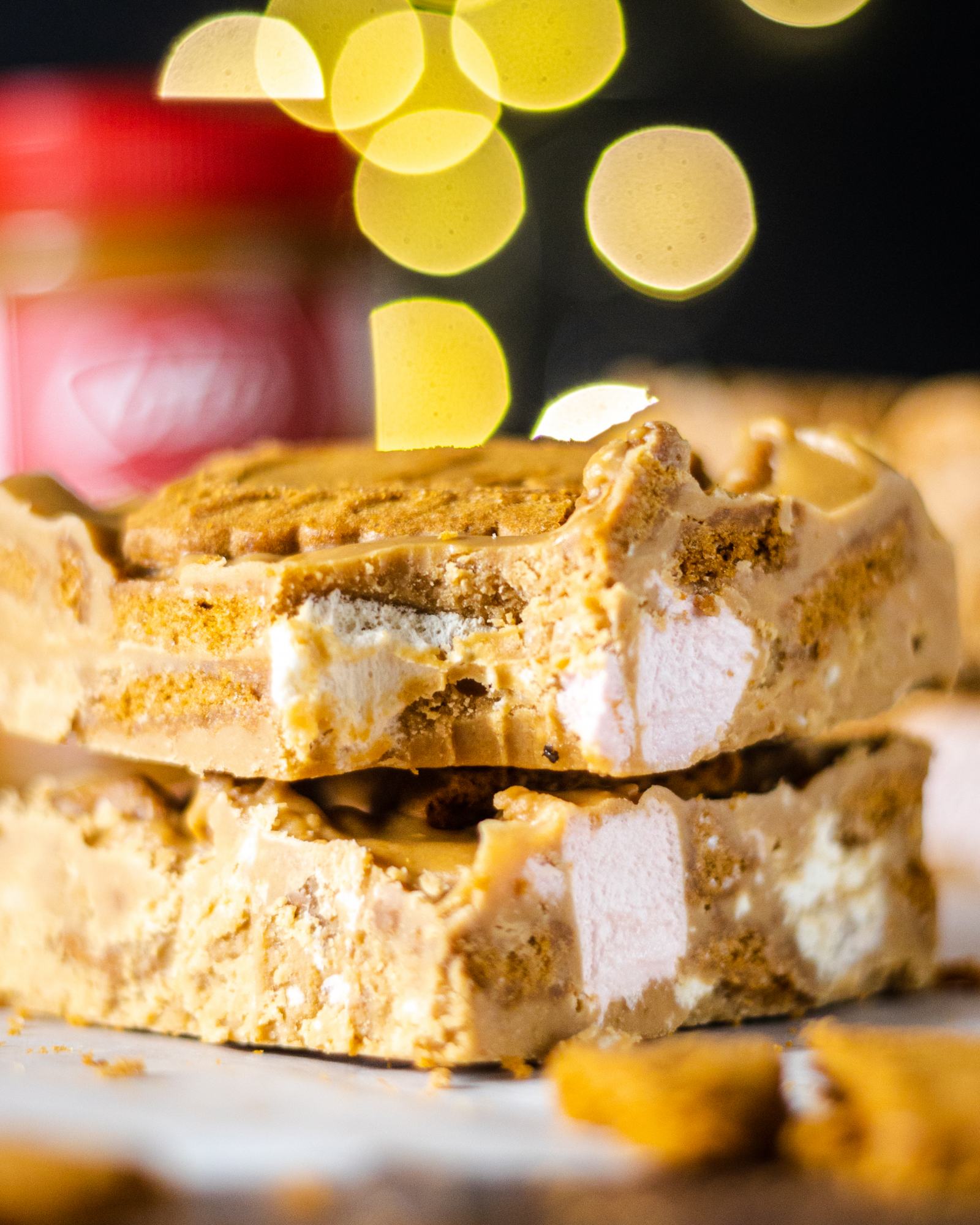 A bite taken out of a Biscoff Rocky Road bar, showing all the layers of this delicious sweet treat.