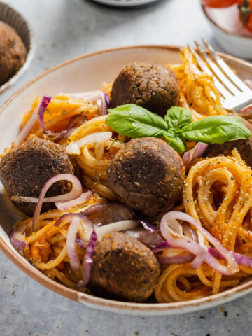 vegan black bean meatballs with spaghetti in a bowl