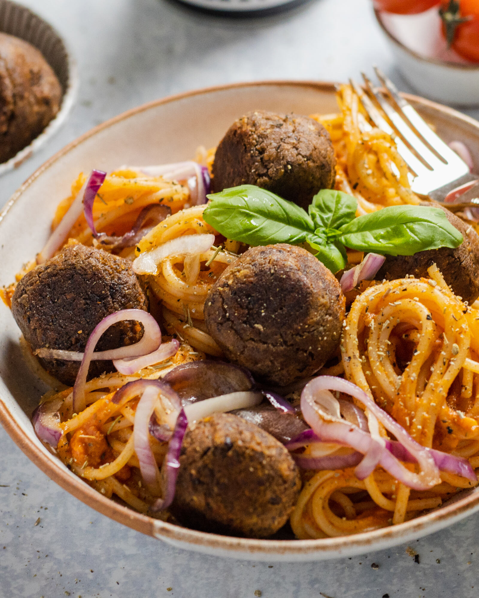 vegan black bean meatballs with spaghetti in a bowl