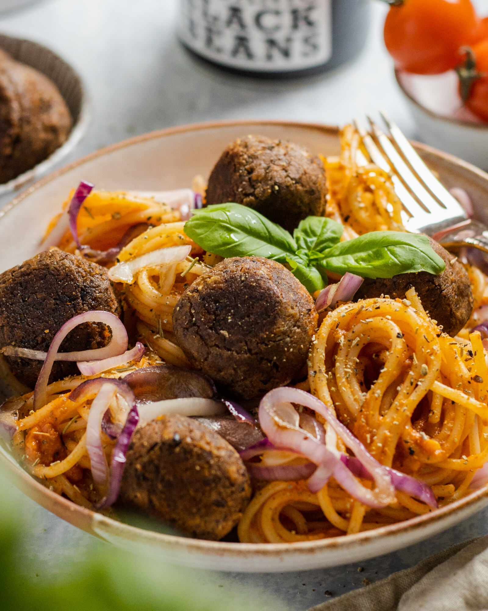 vegan black bean meatballs with spaghetti in a bowl