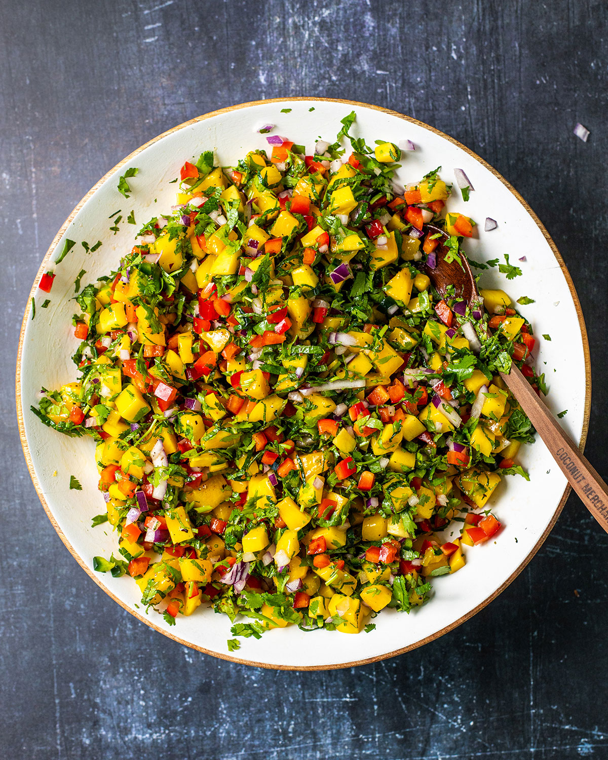 fresh mango salsa in a large bowl on a dark table