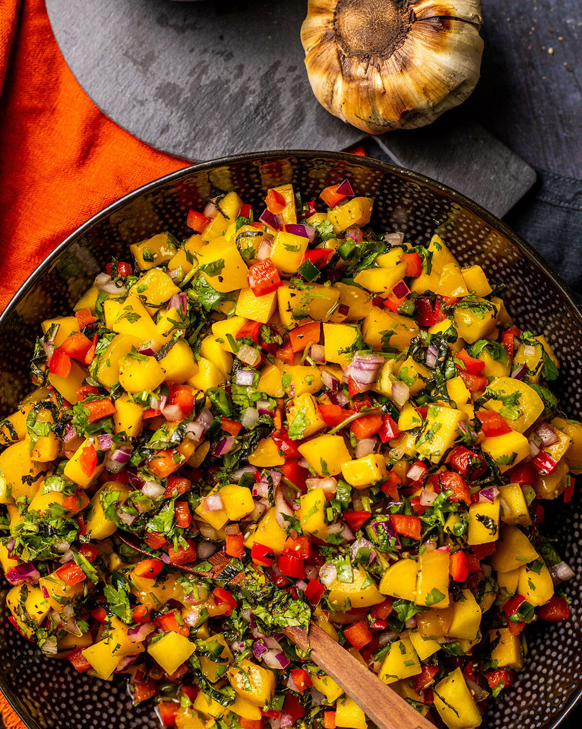 grilled mango salsa in a black bowl