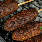 close up of vegan kofta on a barbecue