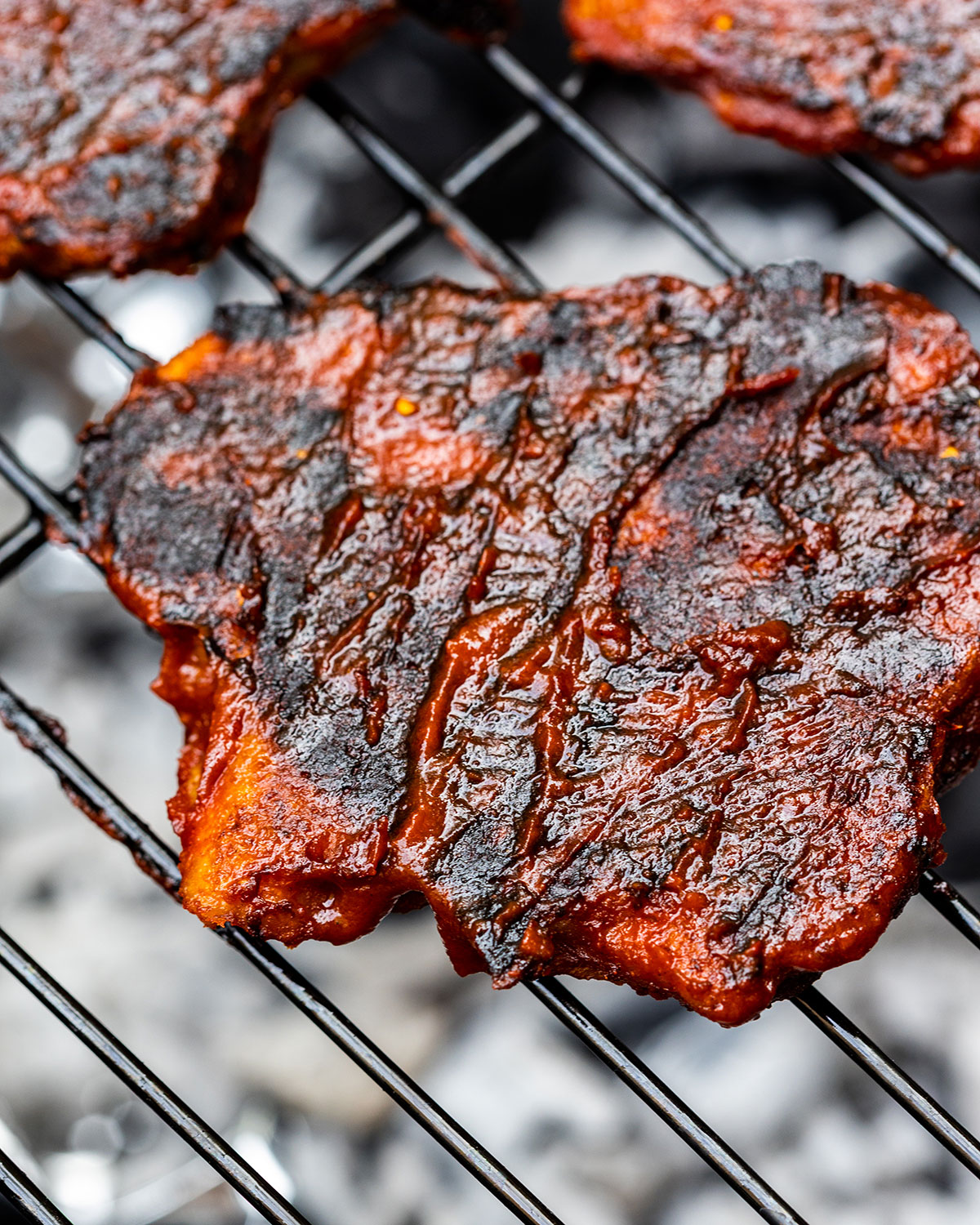 BBQ seitan chicken up close on a BBQ