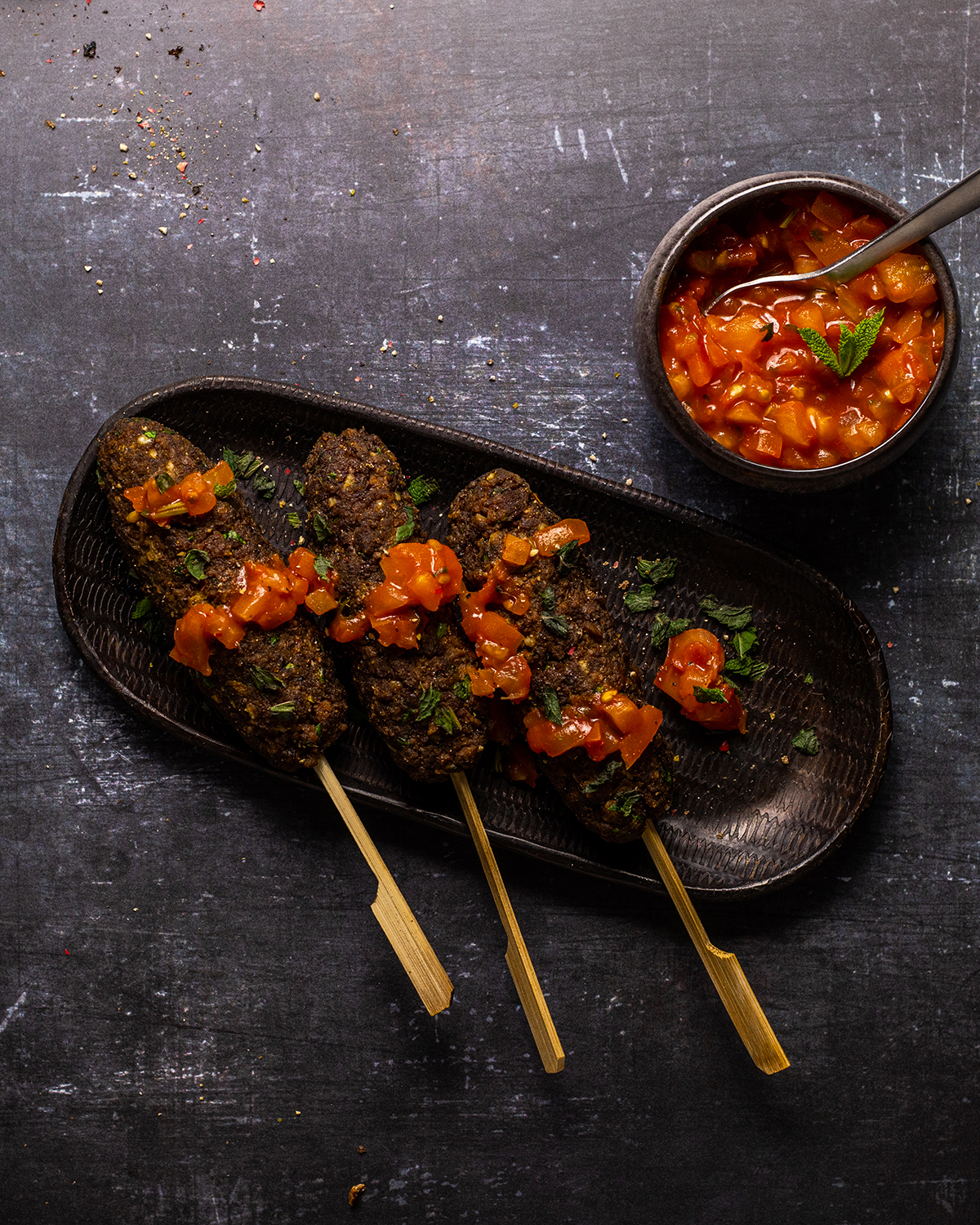 vegan bbq skewers on a serving plate with tomato salsa