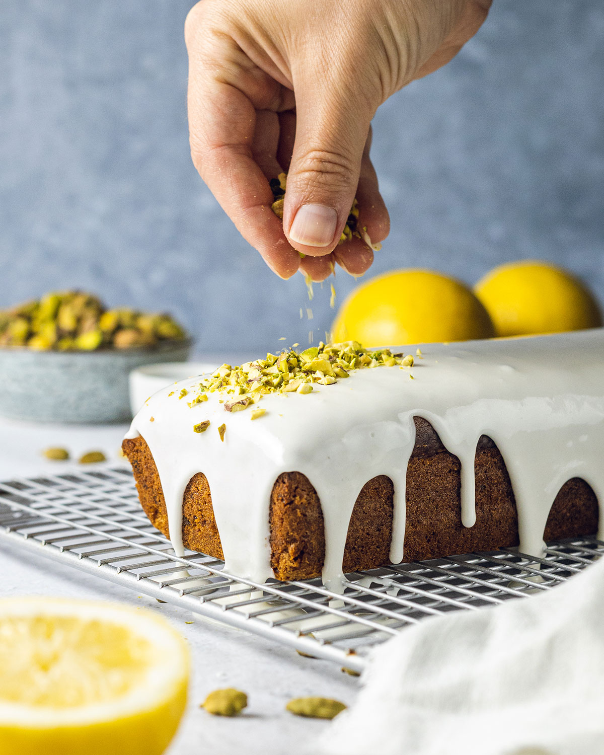 Adding pistachio nuts onto the vegan pistachio cake