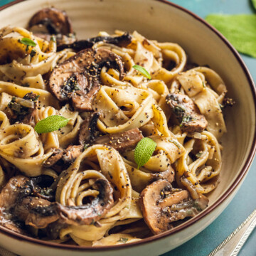 a round bowl filled with vegan mushroom pasta