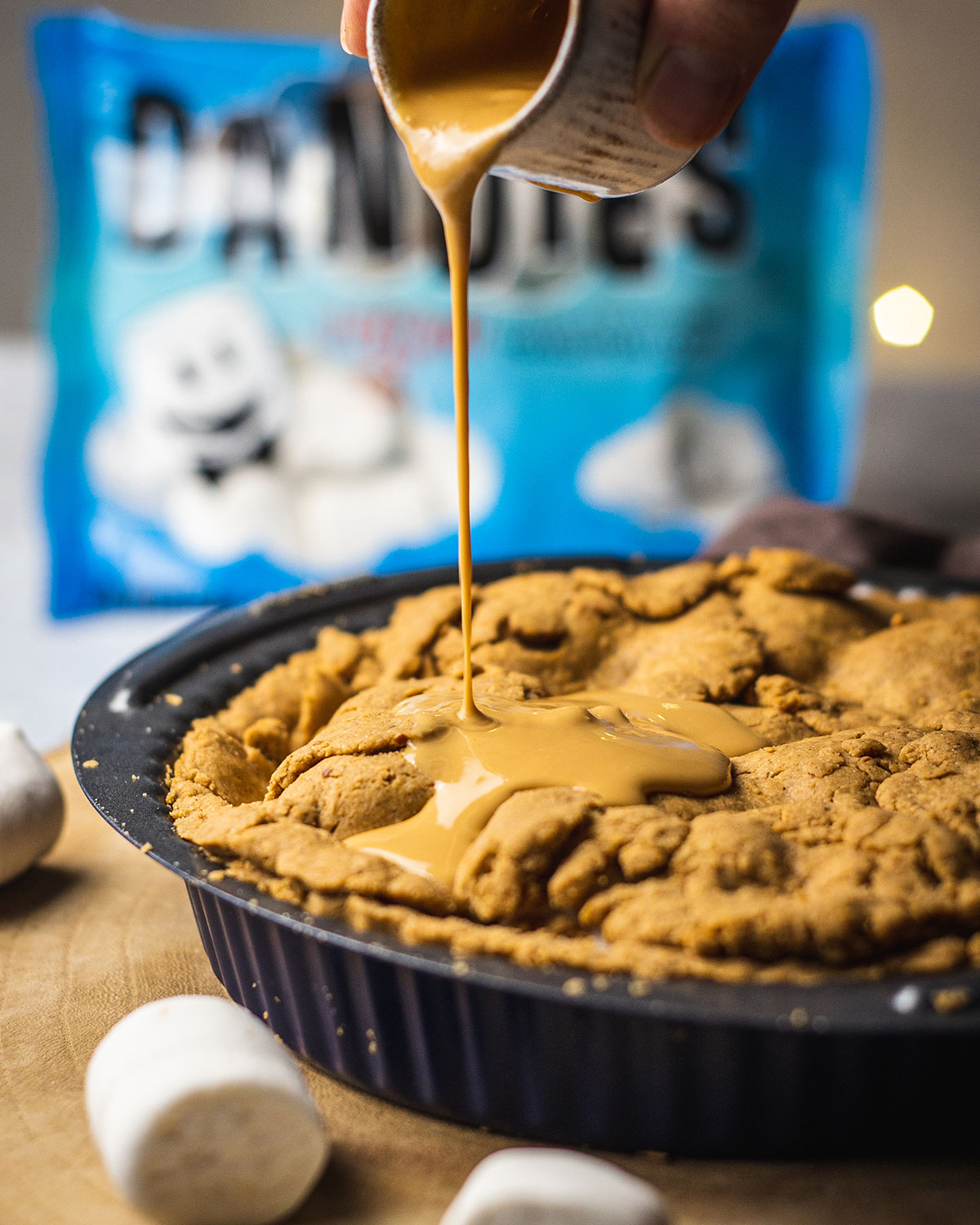 peanut butter being drizzled onto the marshmallow pie