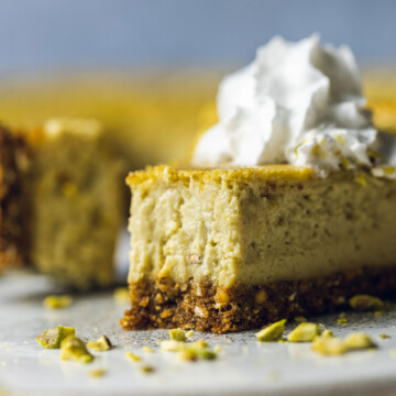 a slice of baked Vegan pistachio cheesecake with a bite taken out of it