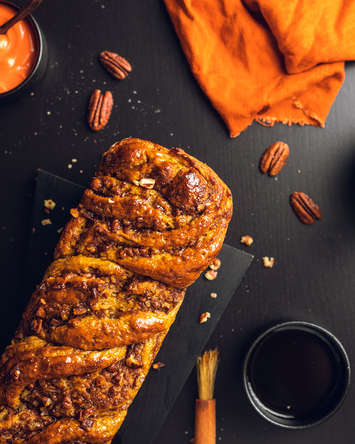 a pumpkin spice loaf photographed from above on a black table