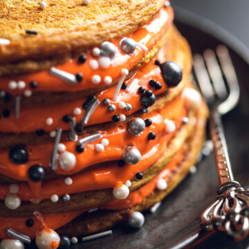 Close-up of a pancake stack filled with orange vegan yoghurt