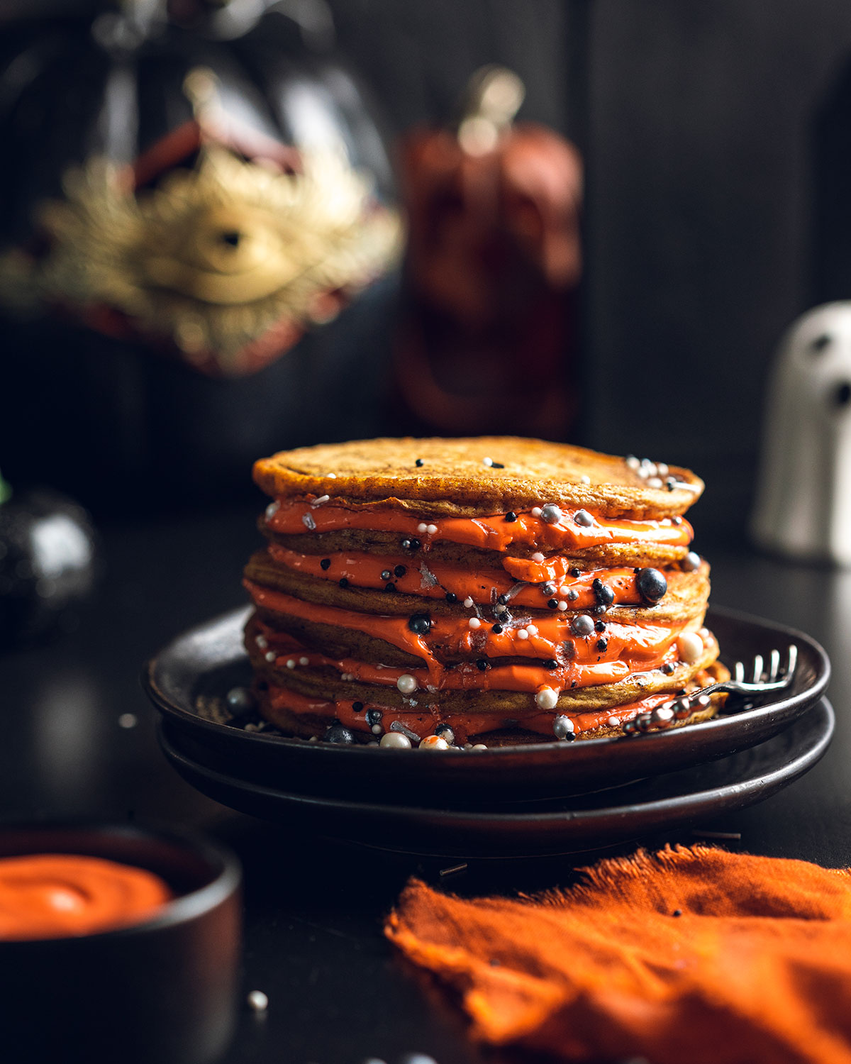 Stack of pumpkin pie pancakes on a black plate