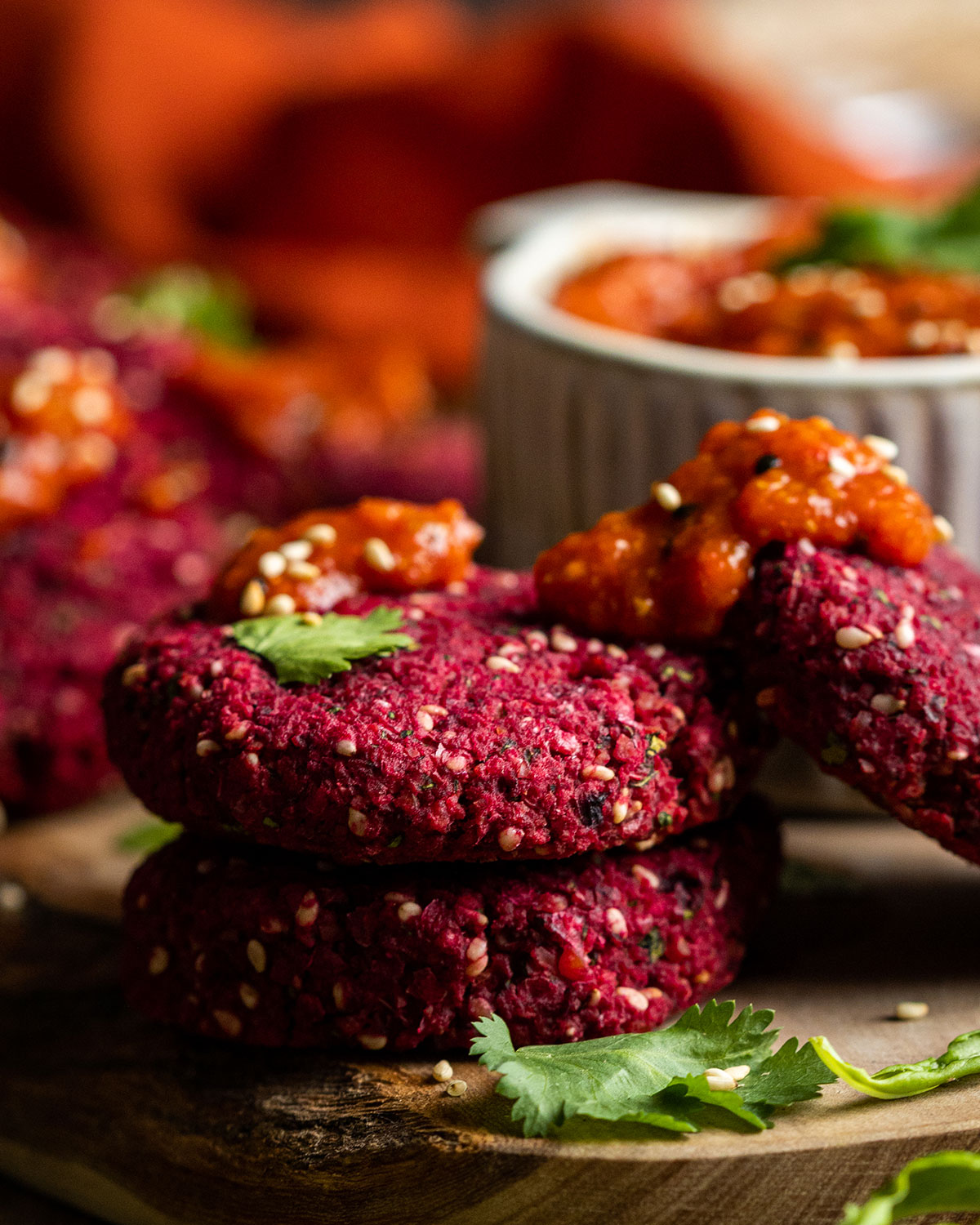 a stack of beetroot falafel on a wooden plate