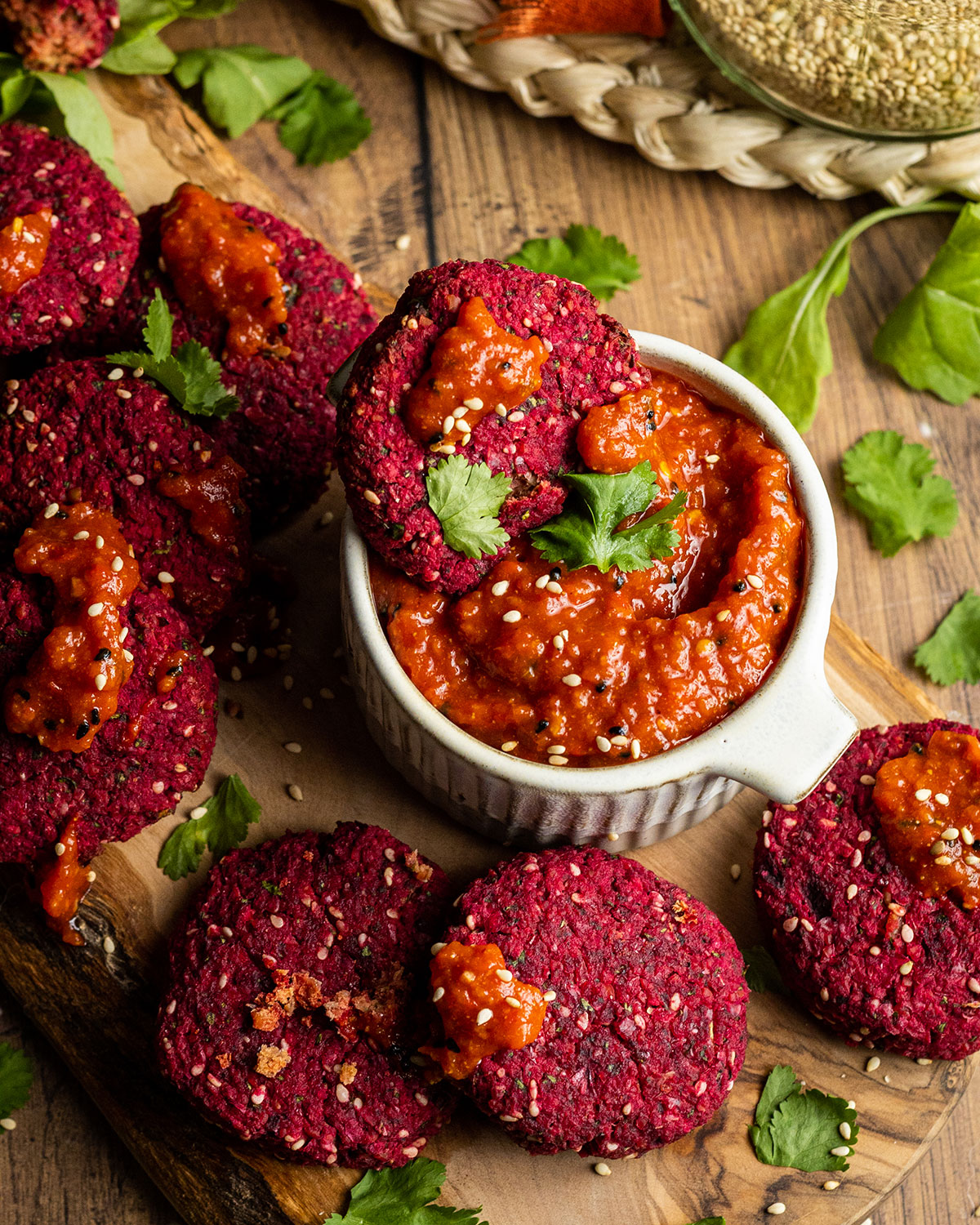 a beetroot falafel dipped into harissa paste