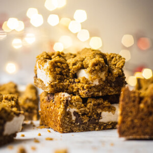 vegan baked oatmeal bars sitting on a stack with a bite taken out of the top