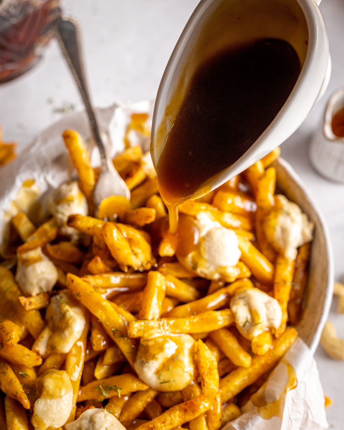 gravy drizzled onto French fries with cheese curds