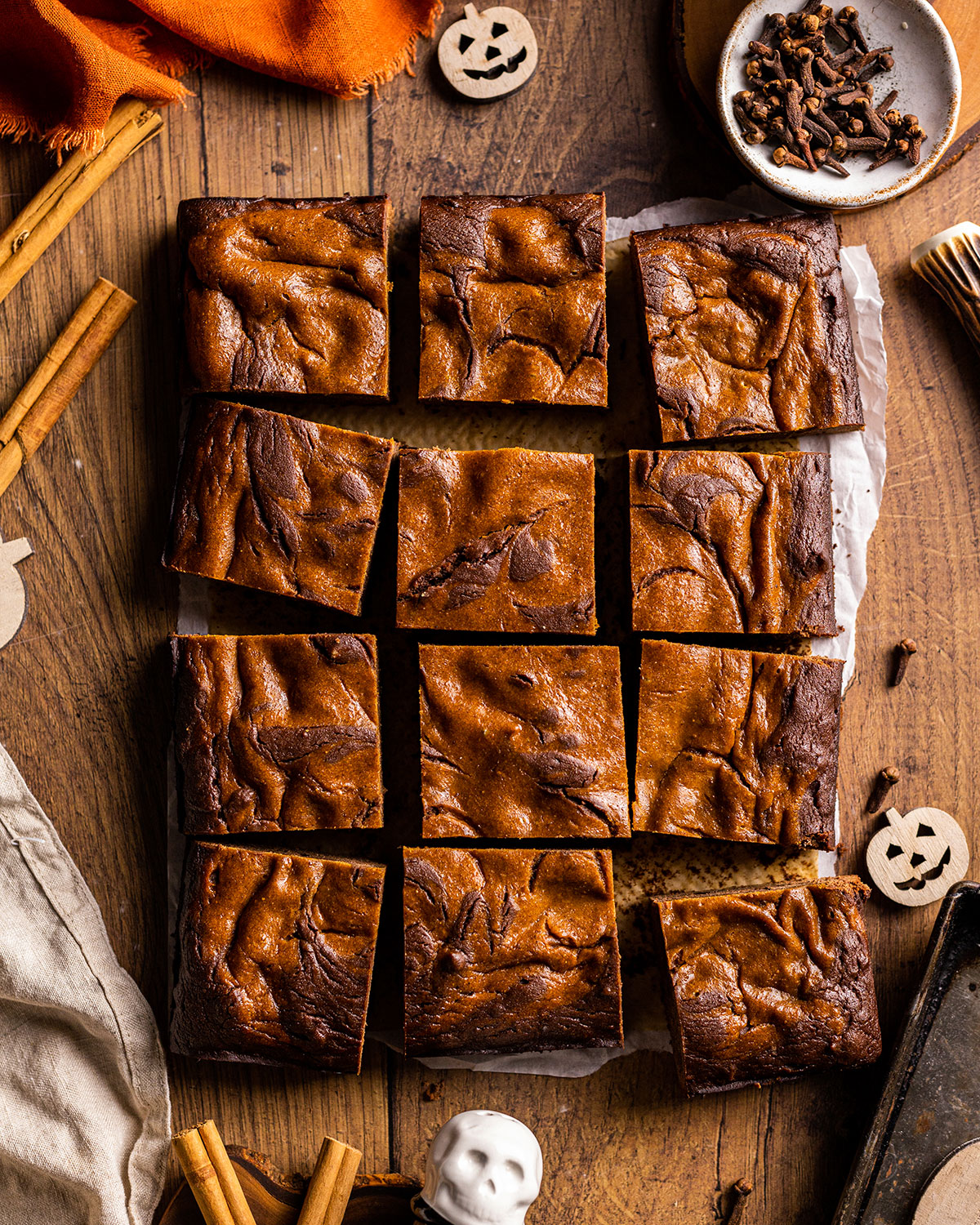 a sheet of pumpkin brownies cut into squares photographed from above