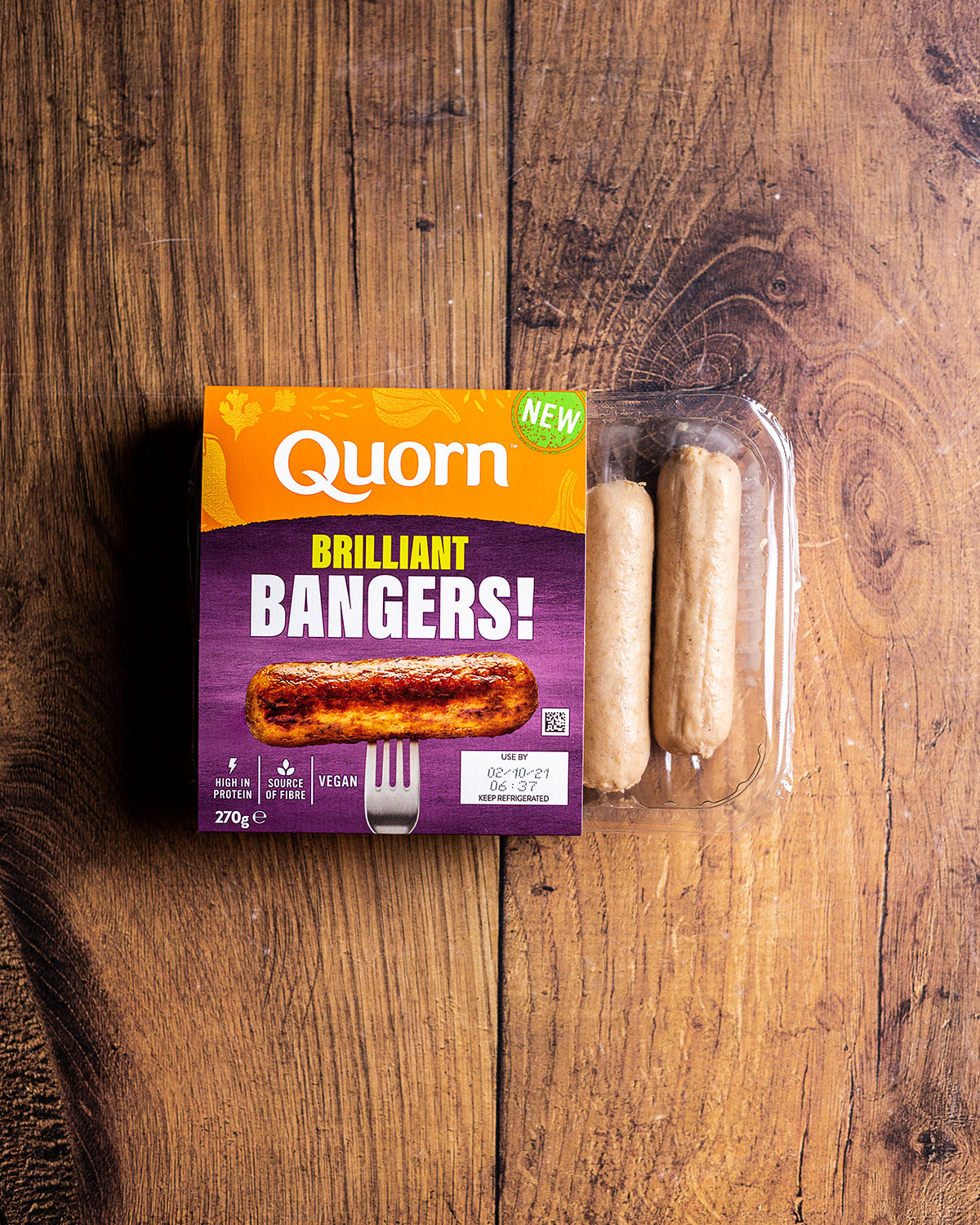 a pack of Quorn vegan sausages on a wooden table