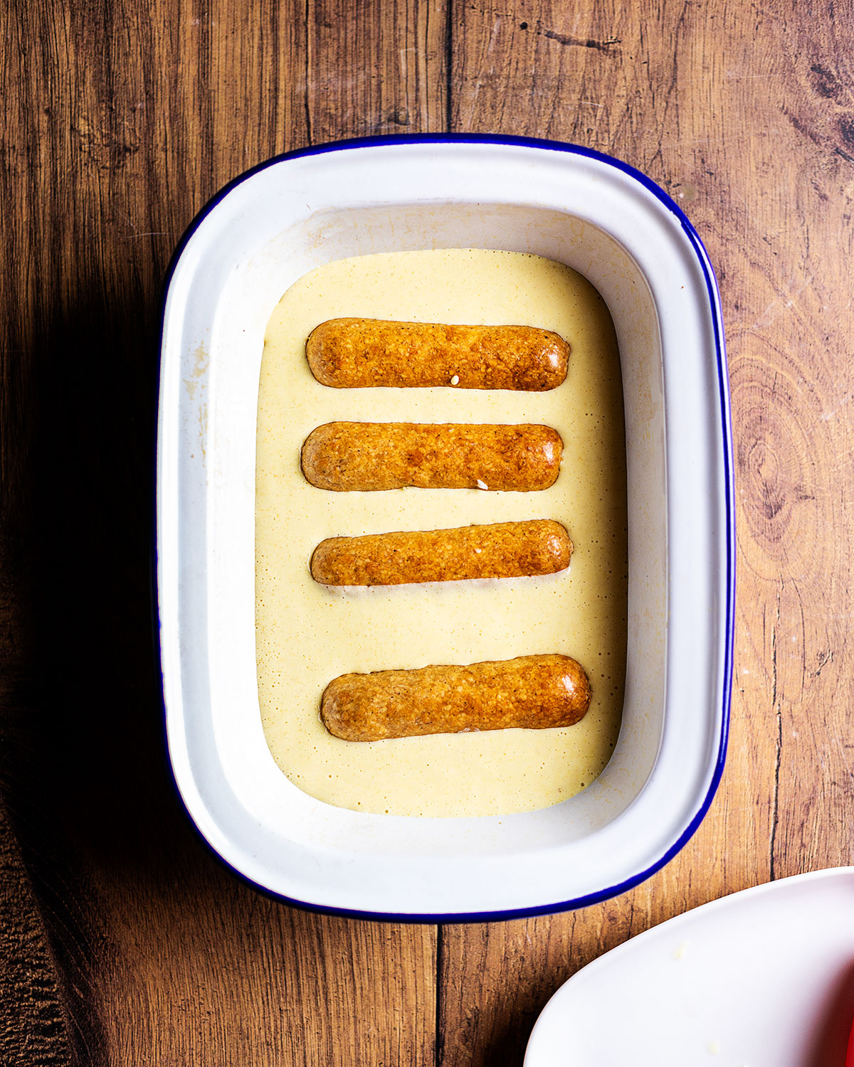 sausages added to the uncooked batter, parallel