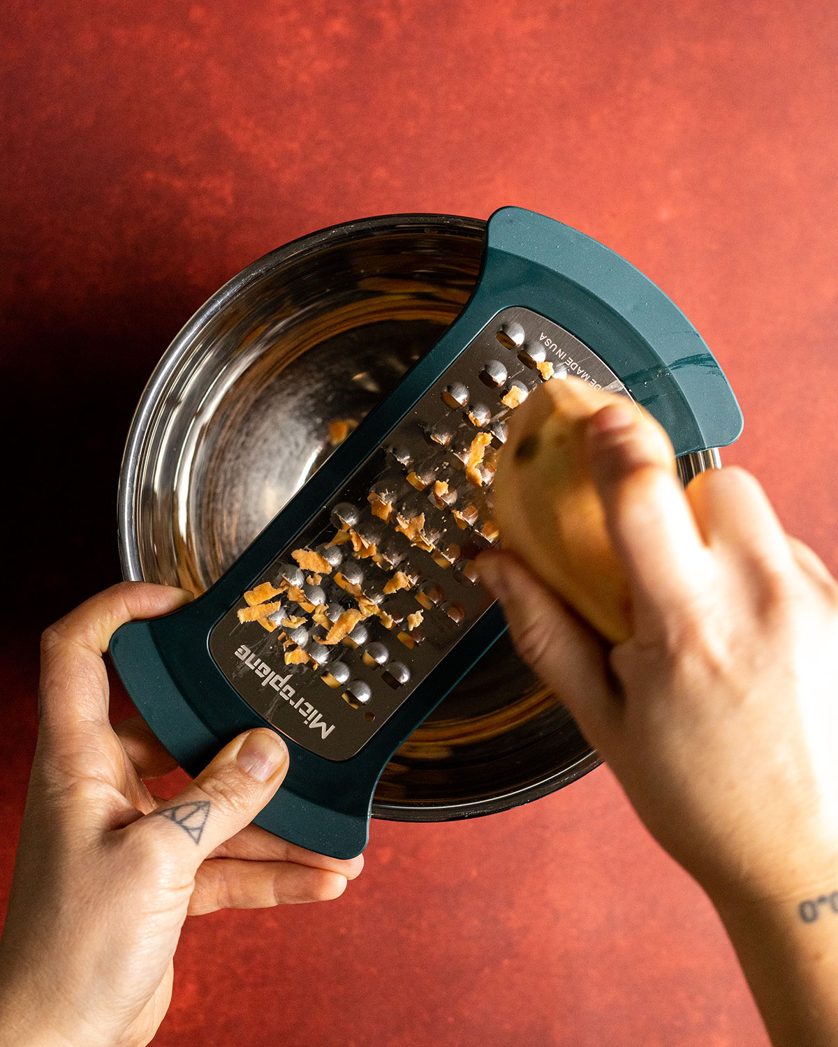 grating a sweet potato into bowl with the Microplane bowl grater