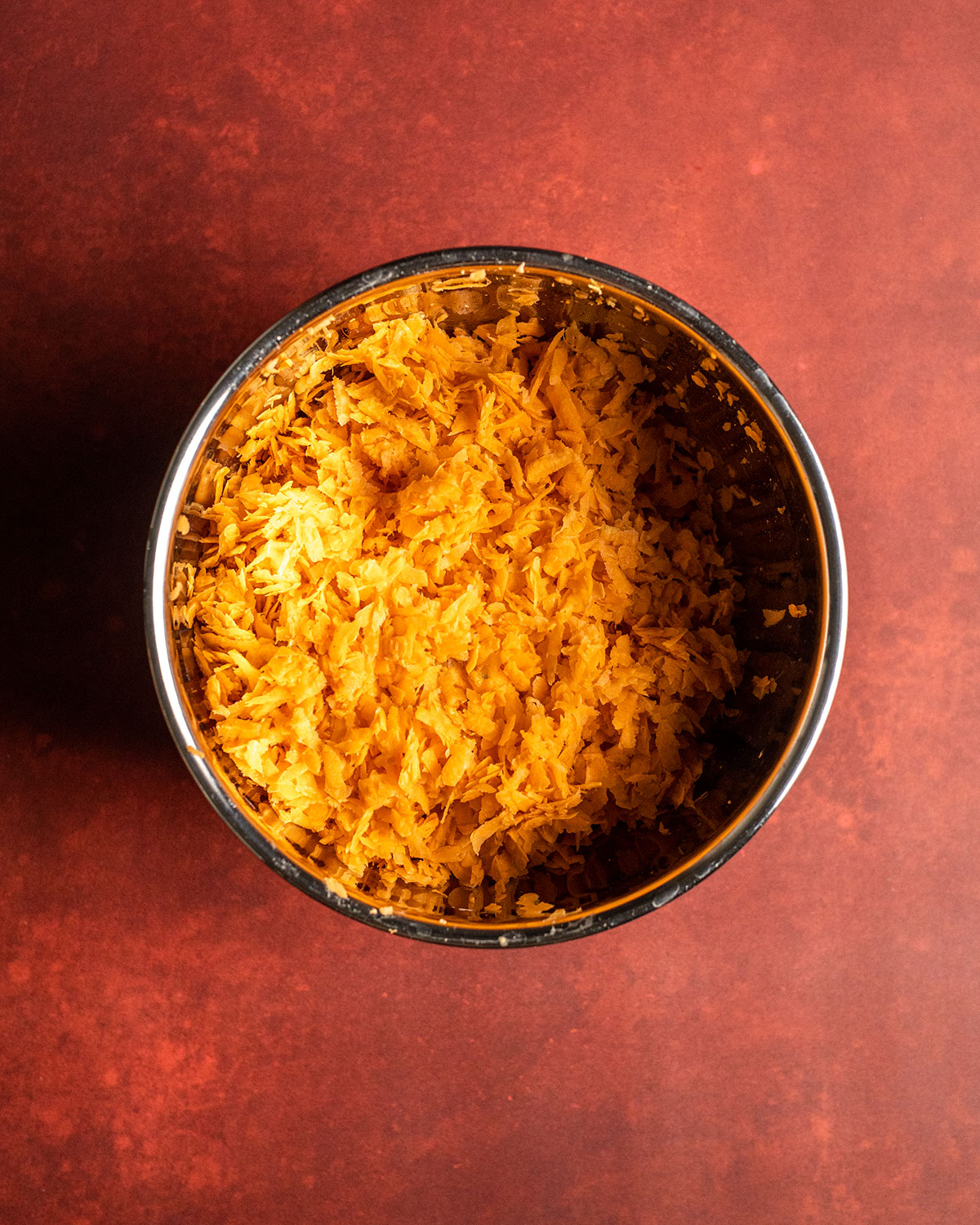 the bowl filled with shredded sweet potato