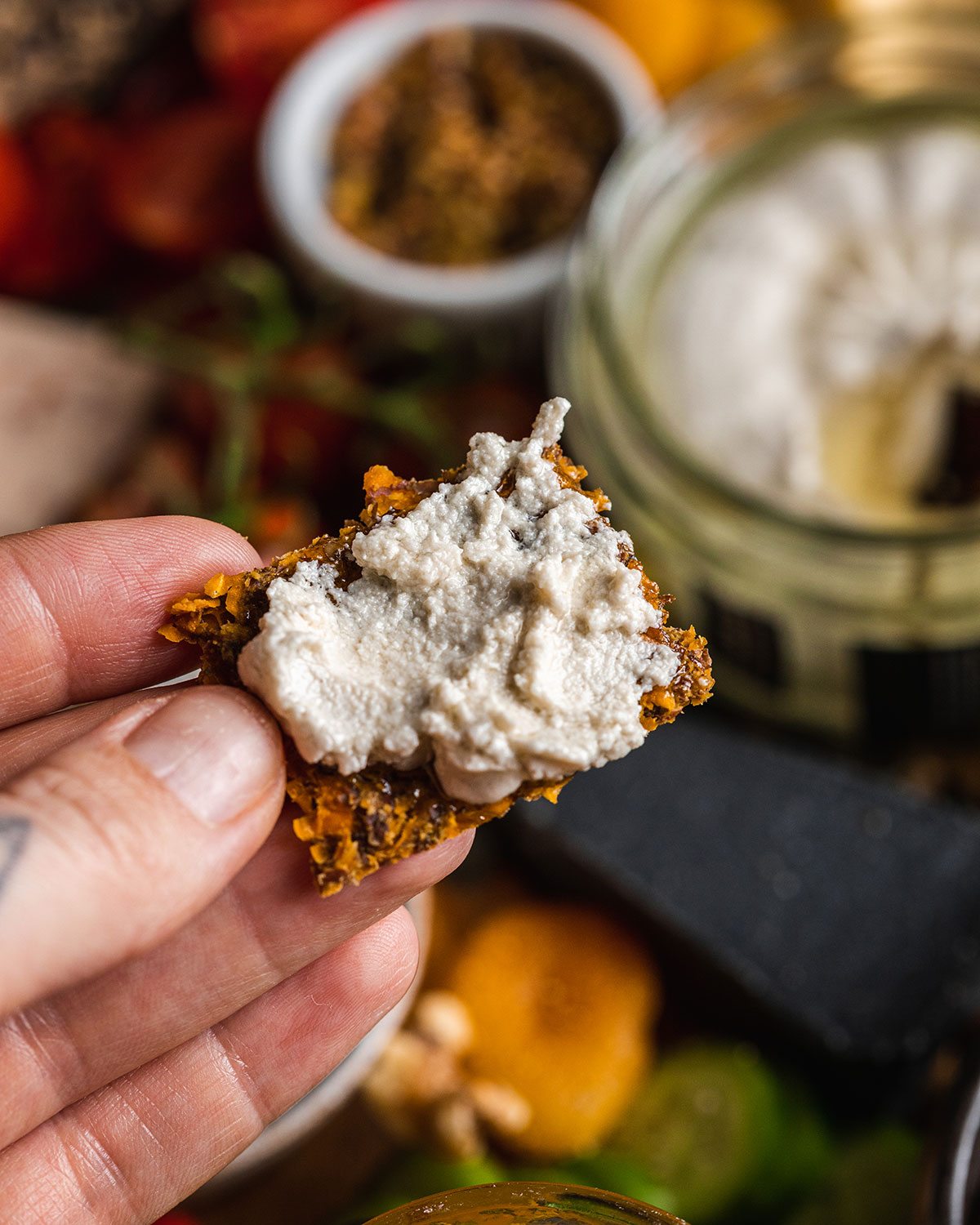 close up of a cracker with vegan cheese