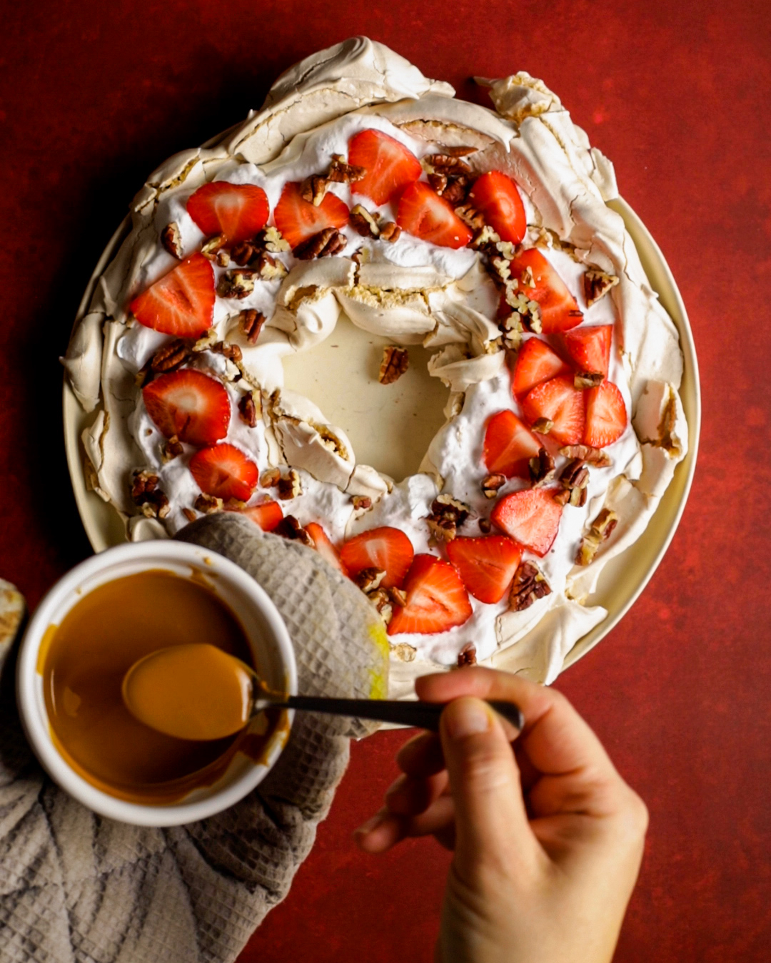 drizzling the pavlova with melted nut butter