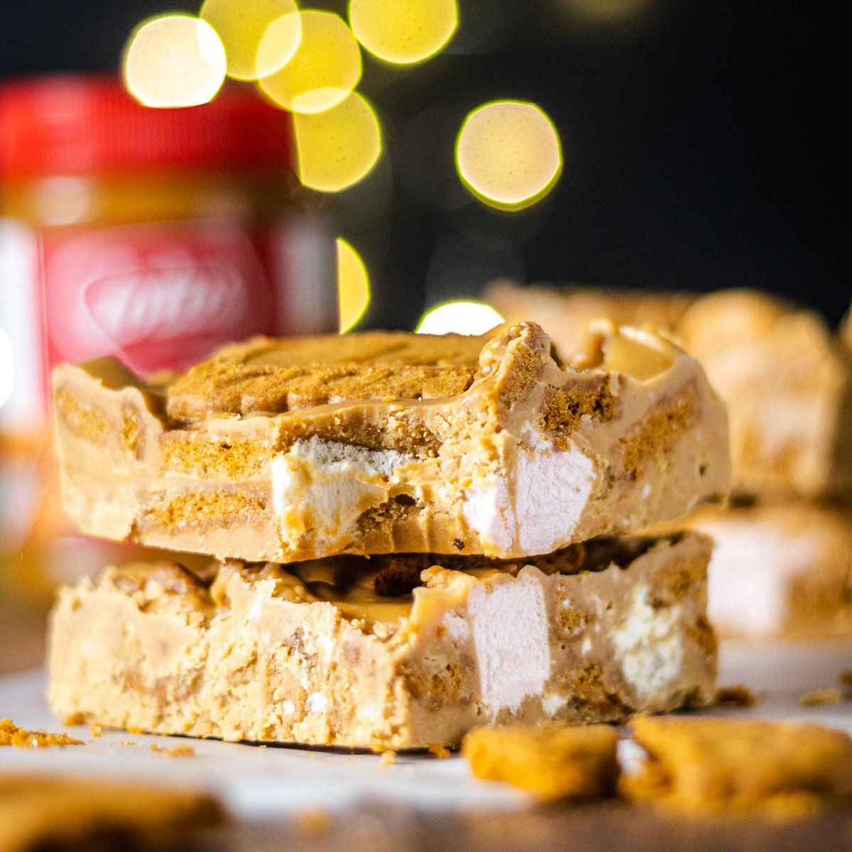 stacked vegan biscoff rocky road with a bite taken out of the top one